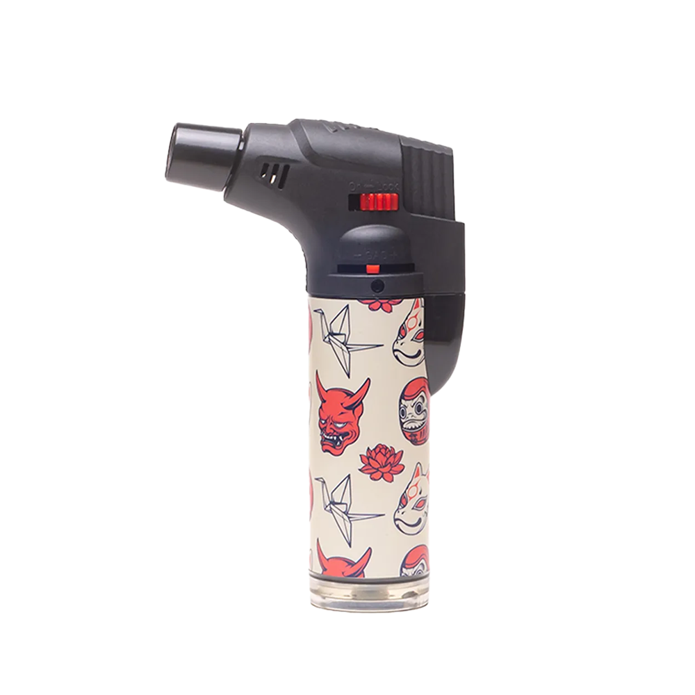 The Special Blue | Bernie Anime Lighter by Vegas Party Favors features a black nozzle and a white body with red and black designs, including a demon mask, paper crane, and lotus. This compact blowtorch offers style and reliability for all your needs.