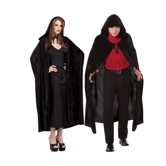 A woman and man in Adult Crushed Velvet Hooded Cloaks Deluxe by Vegas Party Favors exude mystery. The woman pairs hers with a long black dress and heels, while the man opts for a red shirt and black pants. Their serious expressions contrast against the white background.