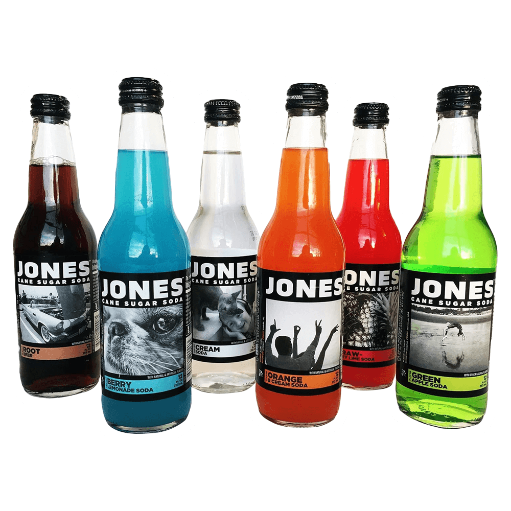 The Jones Soda 12 Pack by Vegas Party Favors includes six colorful bottles with unique flavors: Root Beer, Berry Lemonade, Cream Soda, Orange & Cream, Strawberry Lime, and Green Apple. Each carbonated delight features distinct labels.