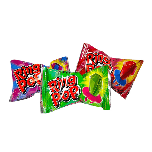Three Vegas Party Favors Ring Pop packages, ideal for party favors, are set against a white backdrop. The colorful wrappers display bright green, blue, red, and pink designs. Each package reveals a wearably dazzling candy gem-shaped lollipop inside.