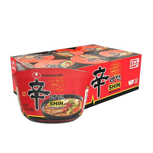 A box of Nongshim Gourmet Spicy Shin Noodle Soup Bowl from Vegas Party Favors includes 12 packs, each 3.03 oz (86g). The red packaging features a noodle bowl image and bold black and white Korean text, promising an authentic spicy instant noodles experience.