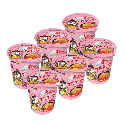 A set of Samyang Buldak Chicken Stir Fried Ramen cups by Vegas Party Favors with pink packaging adorned with a cartoon chicken and red spicy noodles illustration, featuring colorful text and graphics.