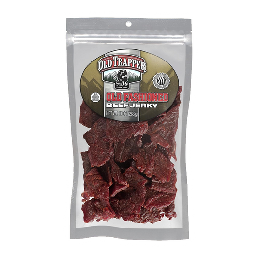 A clear plastic bag of dark red gourmet jerky is labeled Vegas Party Favors Old Trapper Beef Jerky, Old-Fashioned. This protein snack has a net weight of 10 oz (283g), providing 11g of protein, zero fat, and 70 calories per ounce.